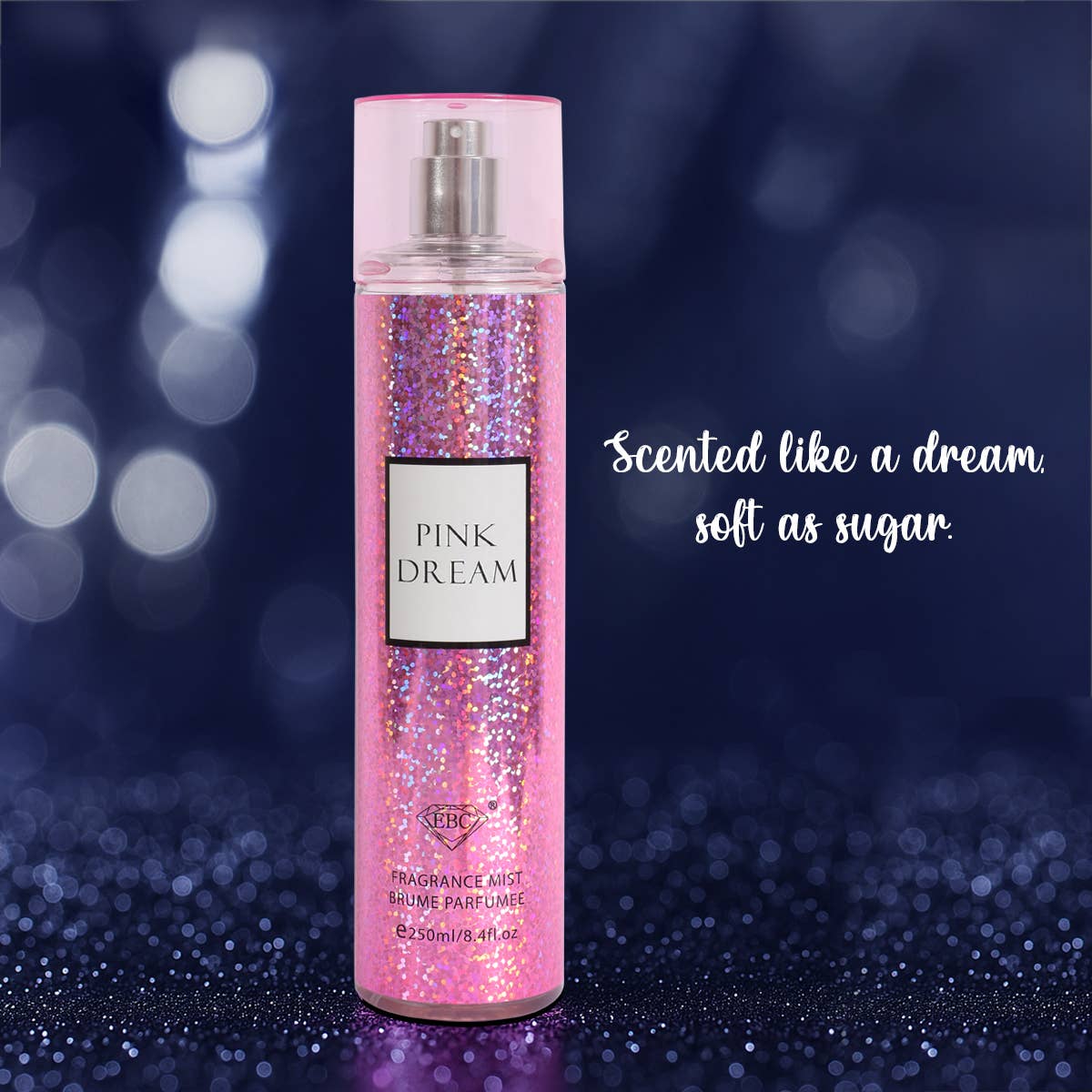 Pink 'Dream' fragrance bottle with glittery design on a dark background
