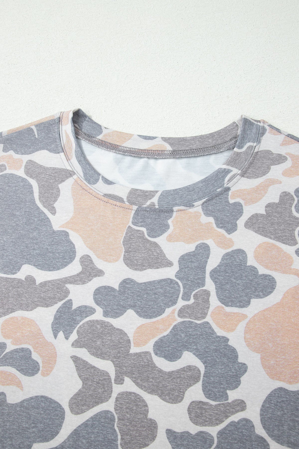 Camouflage-patterned shirt on a white background