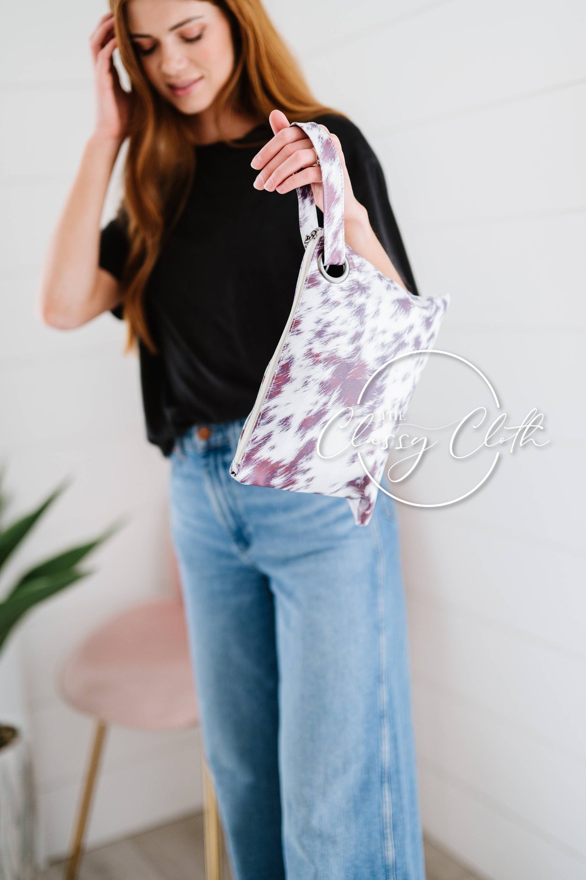 Woman holding a tie-dye handbag with a white background