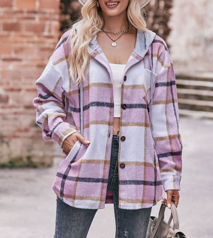 Woman wearing a plaid shirt with a blurred background