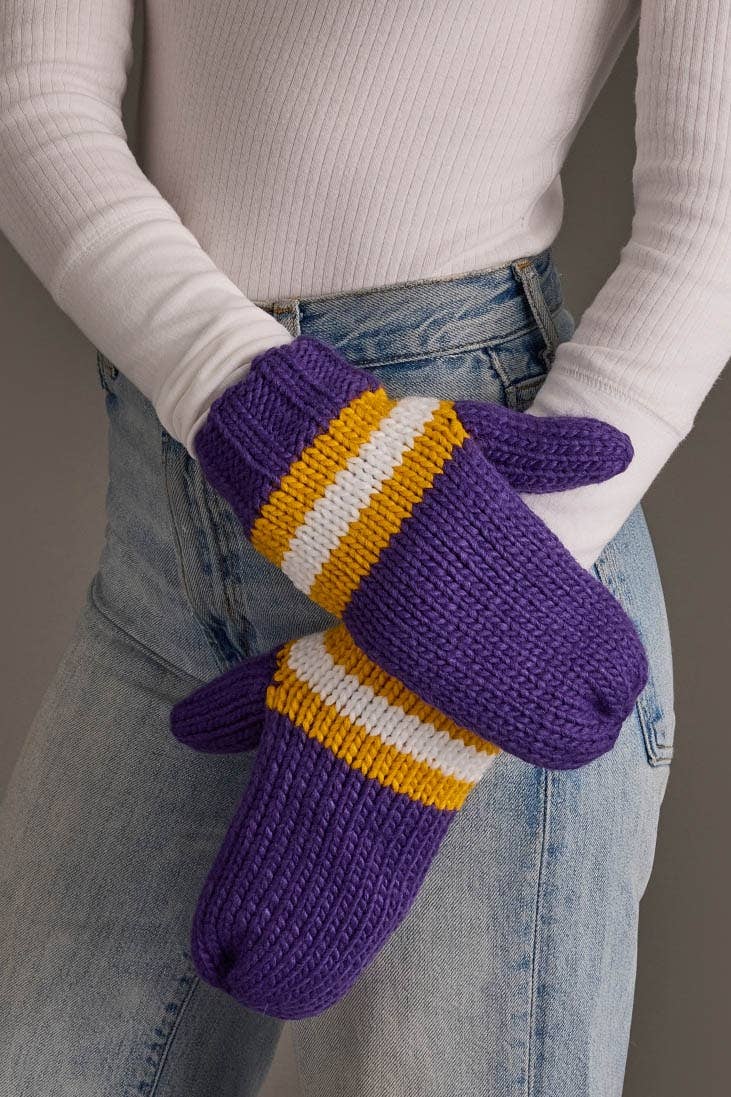 Close-up of purple, gold and white knit winter mittens