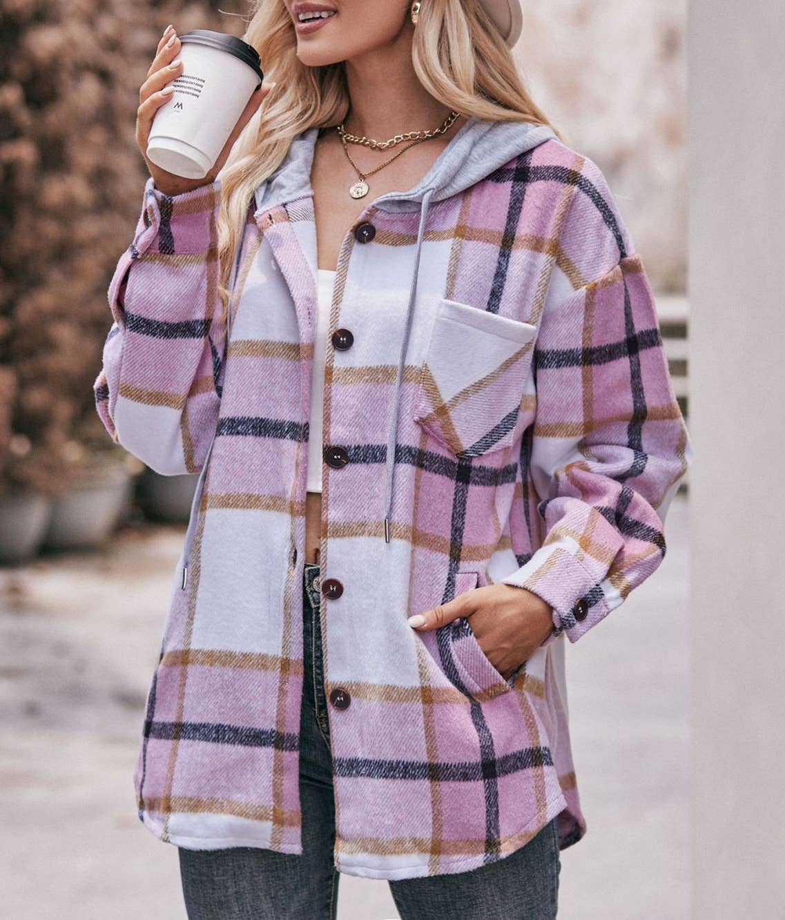 Person wearing a plaid shirt with a blurred background