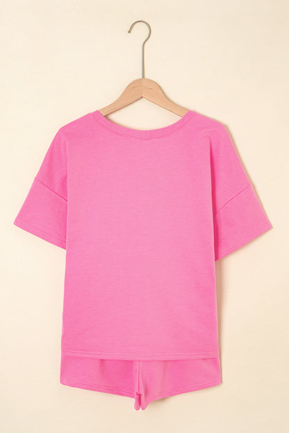 Pink top and shorts set on a beige background