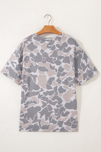 Camouflage-patterned t-shirt on a wooden hanger against a white background