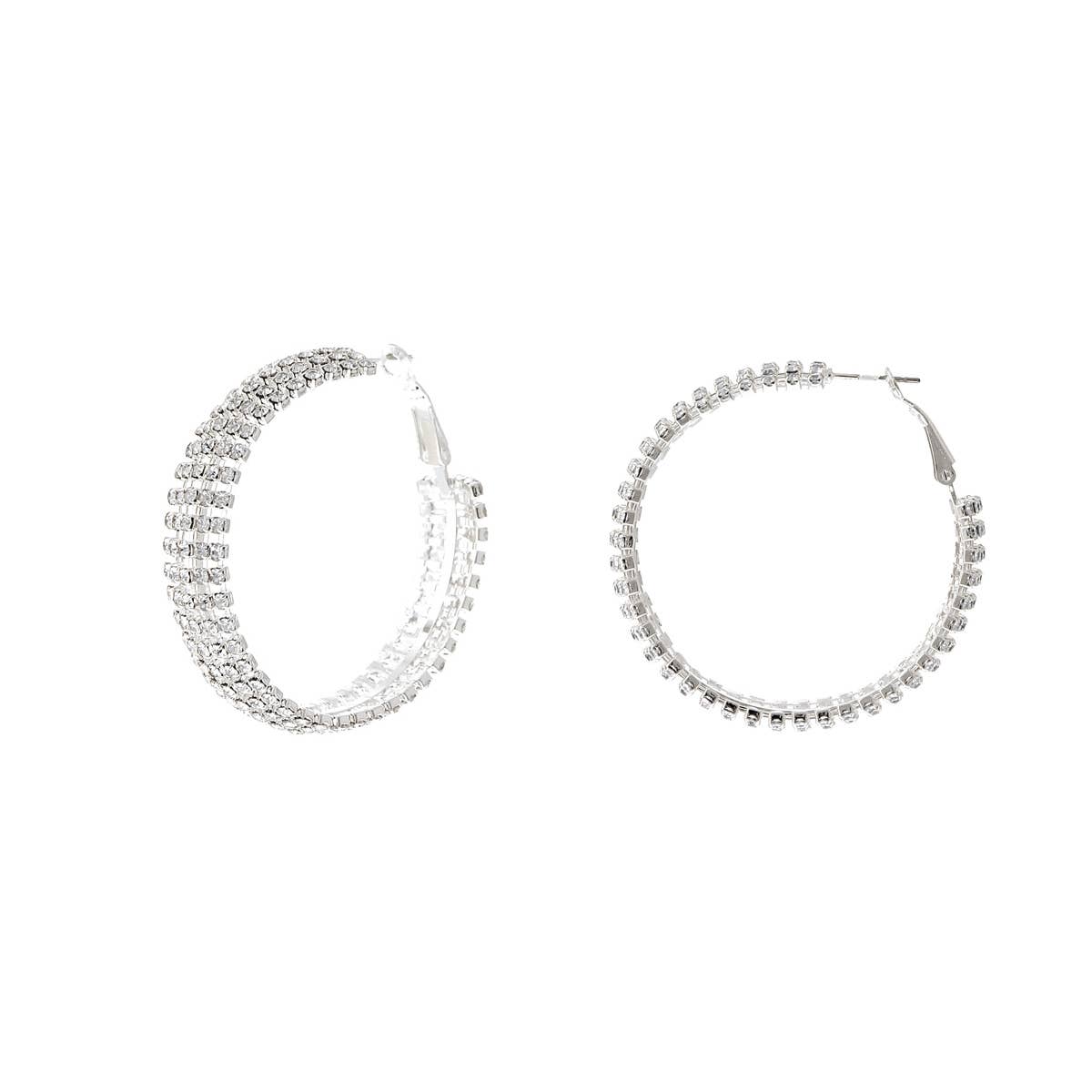 Pair of silver hoop earrings with clear gemstones on a white background