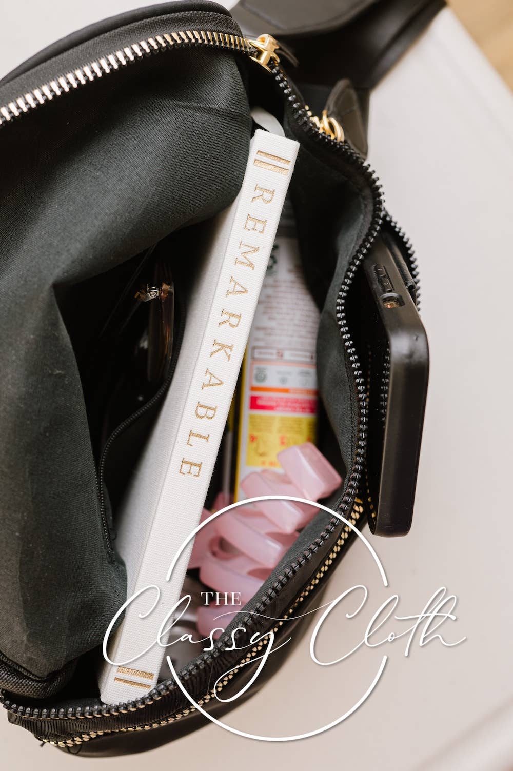 Black bag with a product labeled 'Remarkable' and 'The Classy Cloth' on a light background.