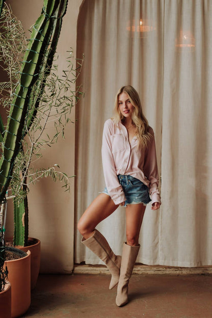 Blush pink long sleeve button-up shirt styled with denim shorts