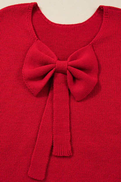 Red sweater with a large bow detail on a beige background