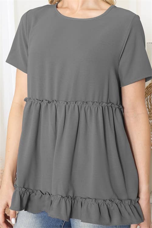 Gray short-sleeve top with ruffled bottom worn by a person.