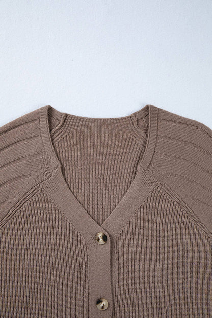 Brown ribbed sweater with buttons on a light blue background