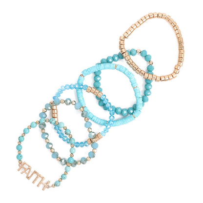 Set of turquoise and gold beaded bracelets on a white background