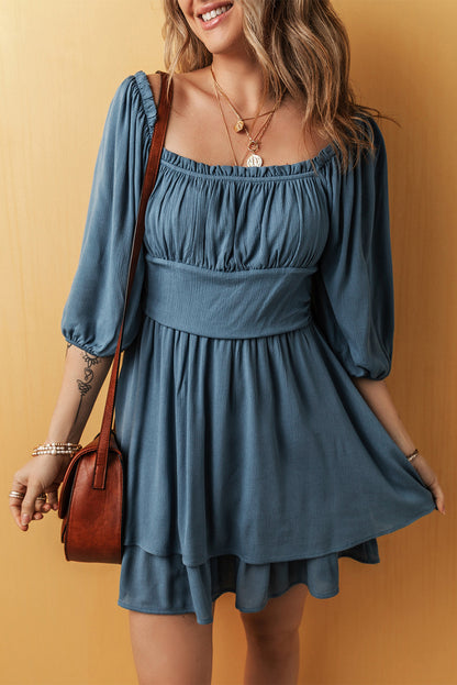 Woman wearing a blue dress with a brown bag against a yellow background