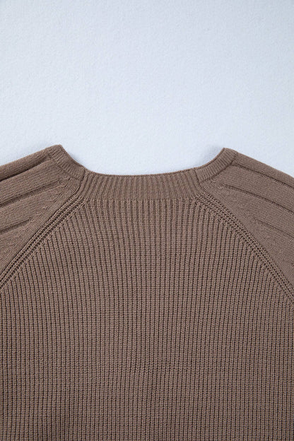 Close-up of a brown ribbed sweater on a light gray background