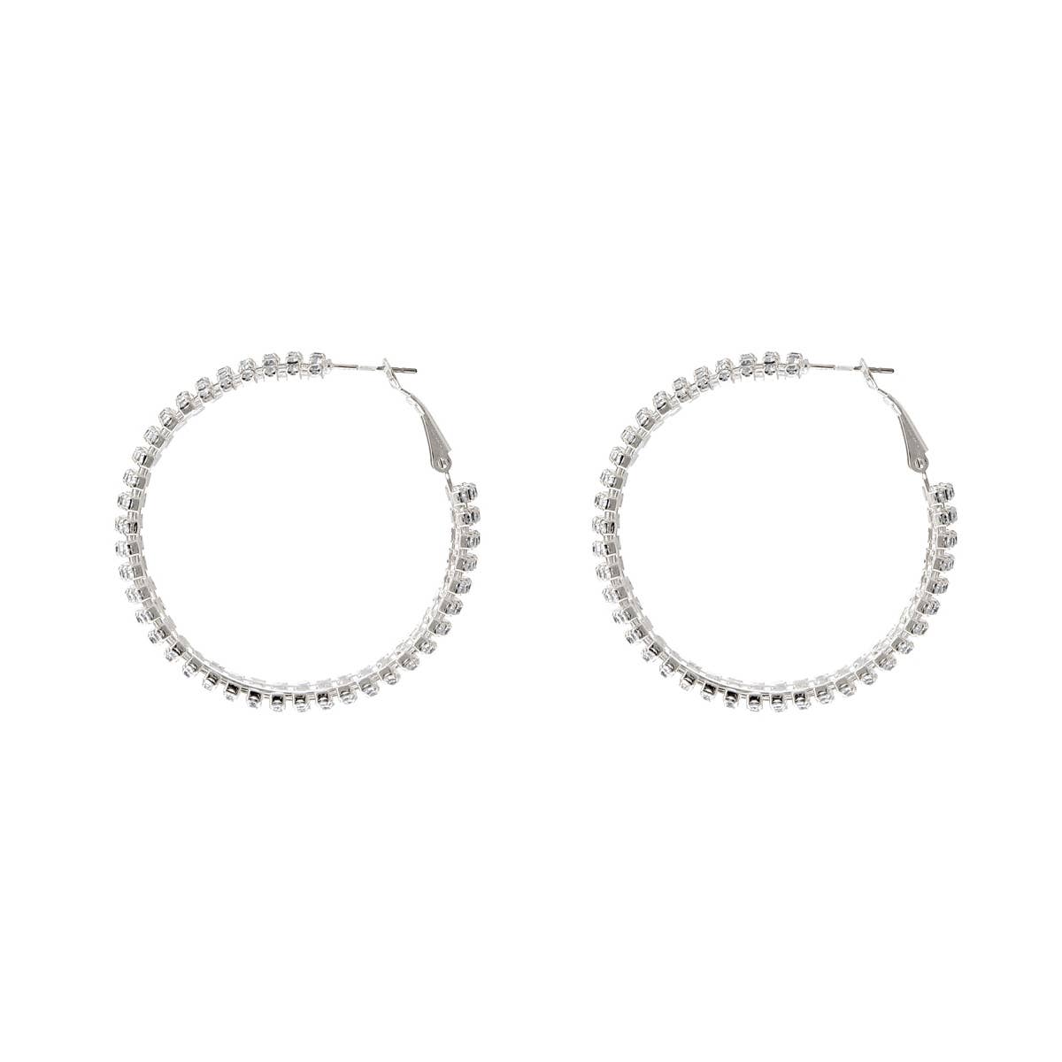 Pair of silver hoop earrings with clear stones on a white background