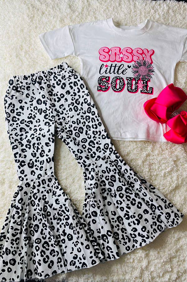 White t-shirt with 'Sassy Little Soul' text and leopard print pants on a textured surface