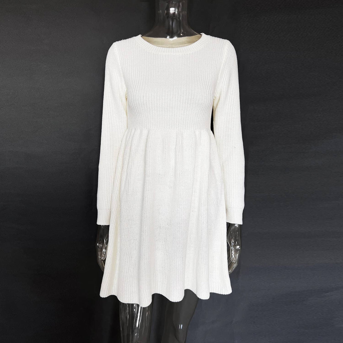 White long-sleeve dress on a mannequin against a black background