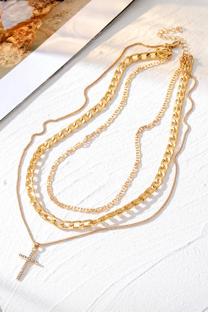 Gold chain necklaces on a textured white surface