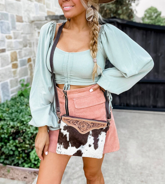 Woman wearing The Mesa genuine cowhide and tooled leather western crossbody bag