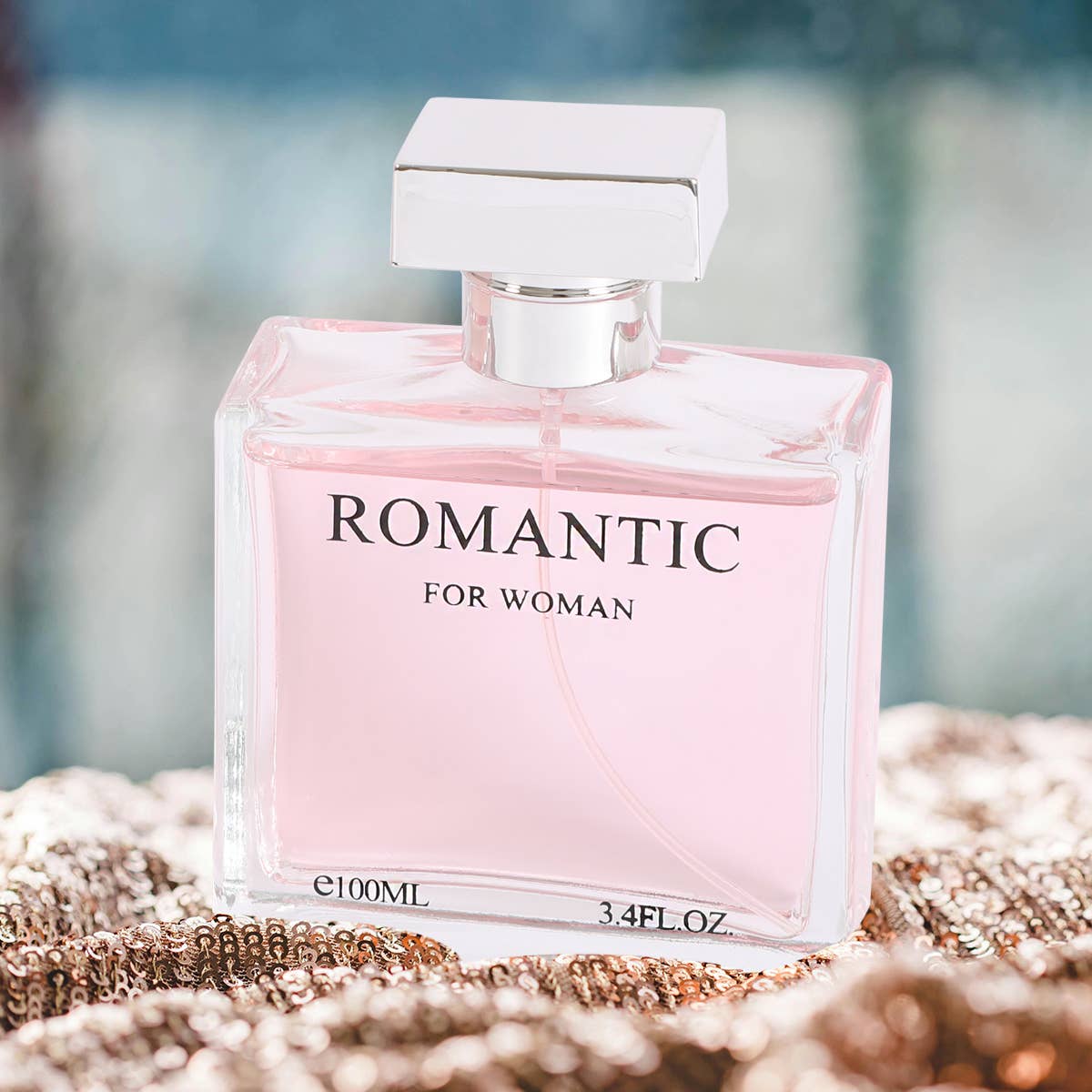 Perfume bottle labeled 'Romantic for Woman' on a textured surface with a blurred background