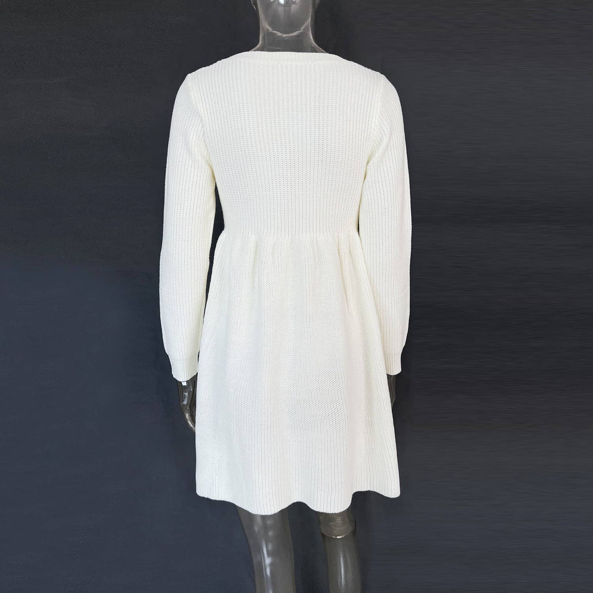 White ribbed dress on a mannequin against a dark background