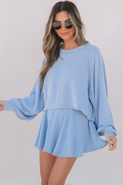 Woman wearing a light blue outfit with a plain background
