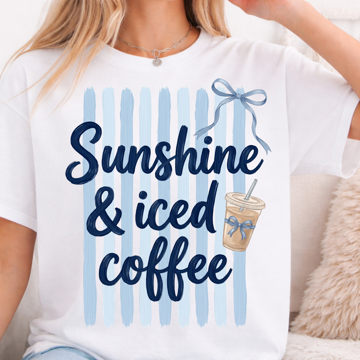 White t-shirt with 'Sunshine & iced coffee' text and a coffee cup graphic on a striped background.