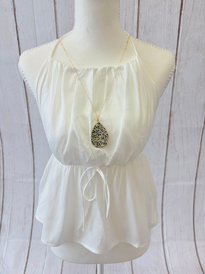 White strapless dress with a bow on a mannequin against a wooden background