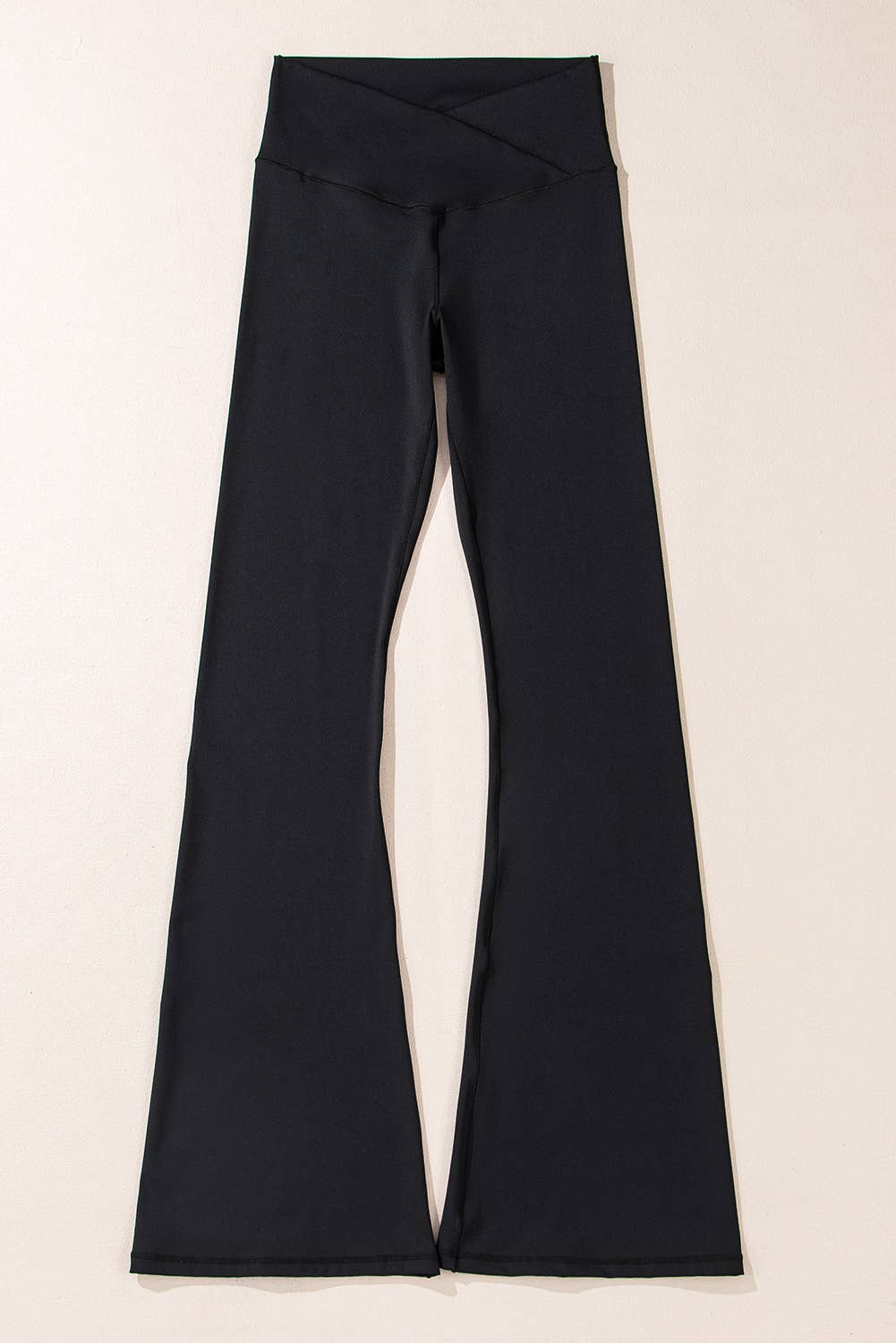Black pants on a light beige background