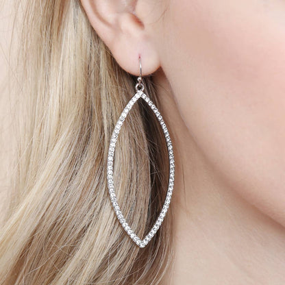 Silver hoop earrings worn by a person with blonde hair.