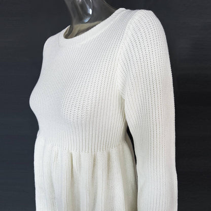 White knit dress on a mannequin against a dark background