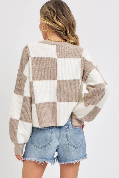 Person wearing a checkered sweater and denim shorts on a white background