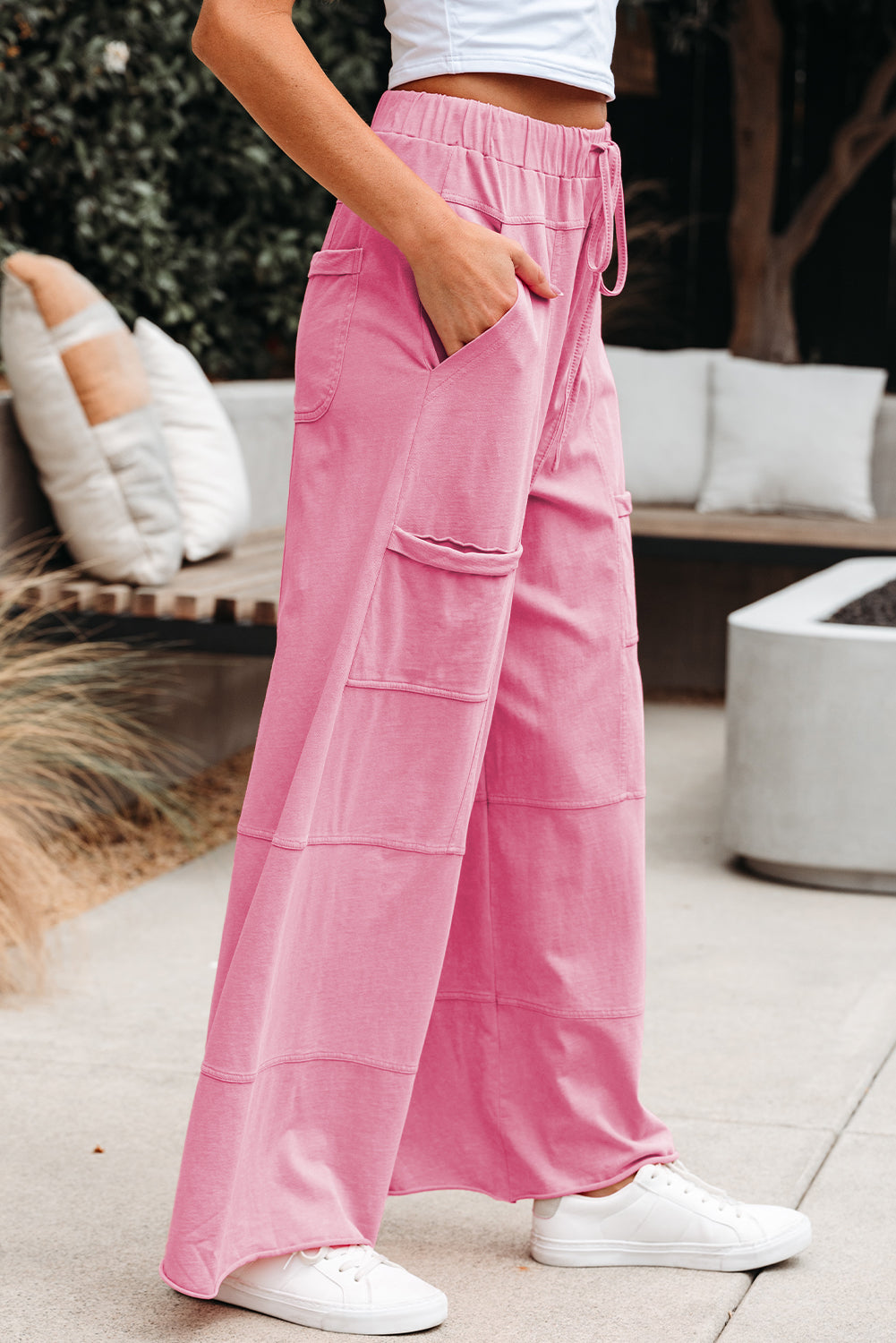 Person wearing pink cargo pants with a blurred background