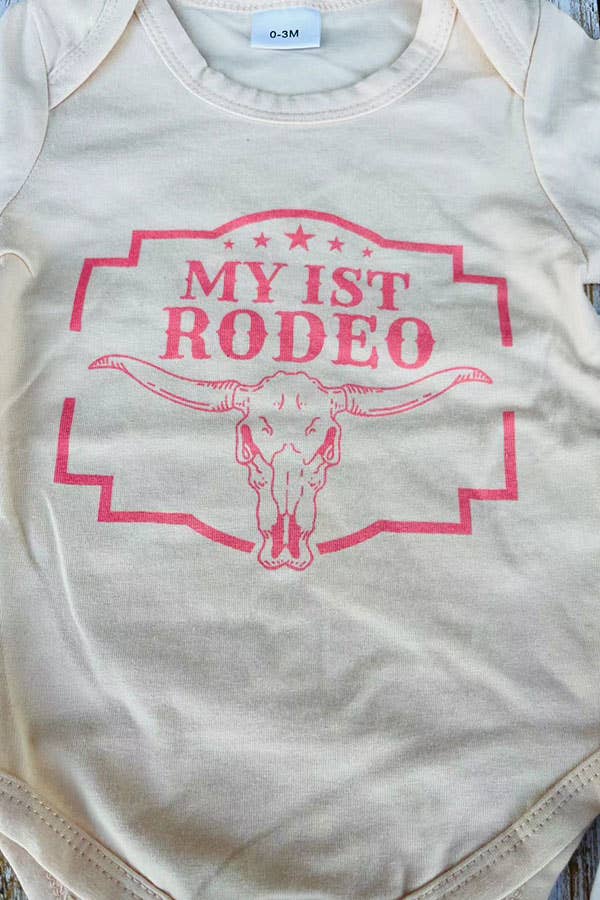 Baby onesie with 'My 1st Rodeo' text and bull skull design on a light background