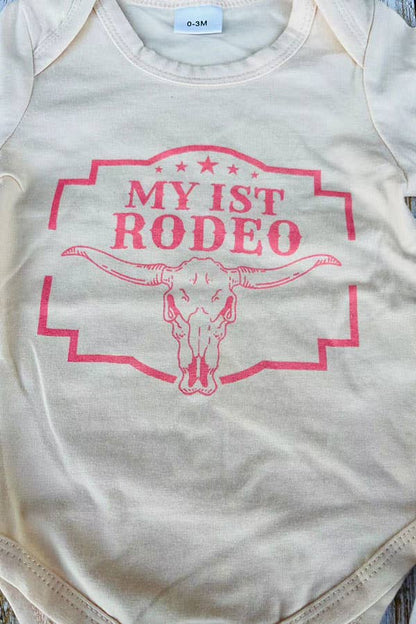Baby onesie with 'My 1st Rodeo' text and bull skull design on a light background