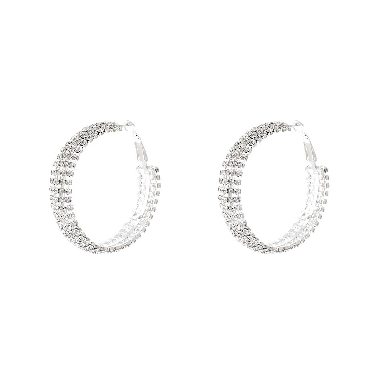 Pair of silver hoop earrings with clear stones on a white background