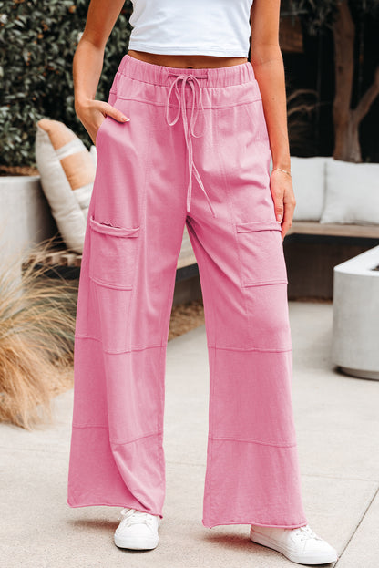 Person wearing pink pants with pockets in an outdoor setting