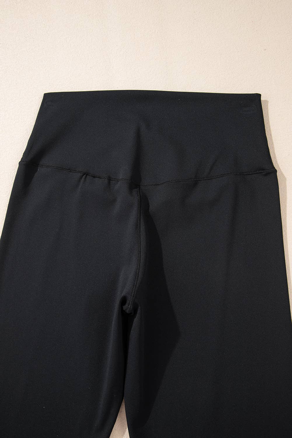 Black pants on a beige background