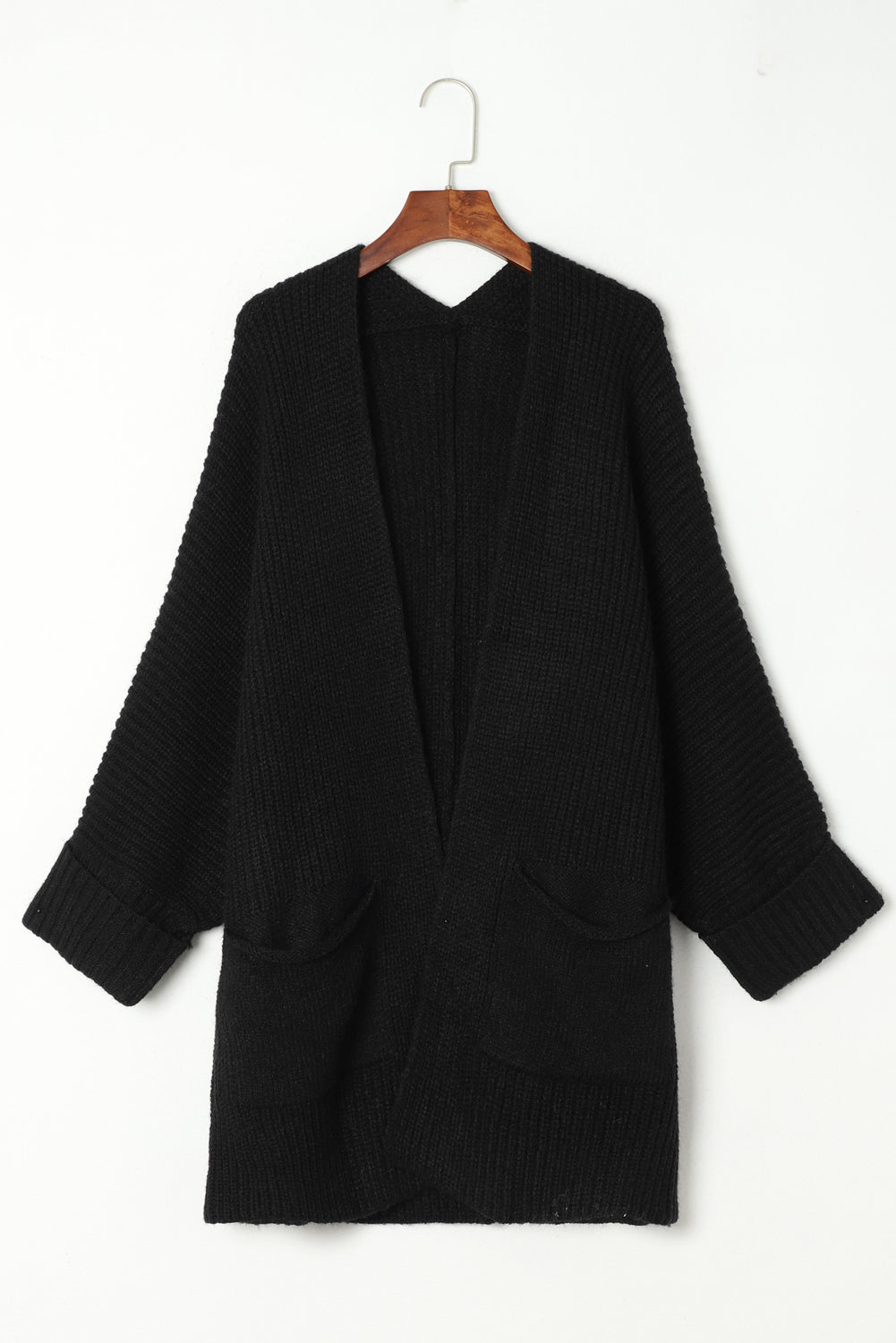 Black sweater on a wooden hanger against a white background