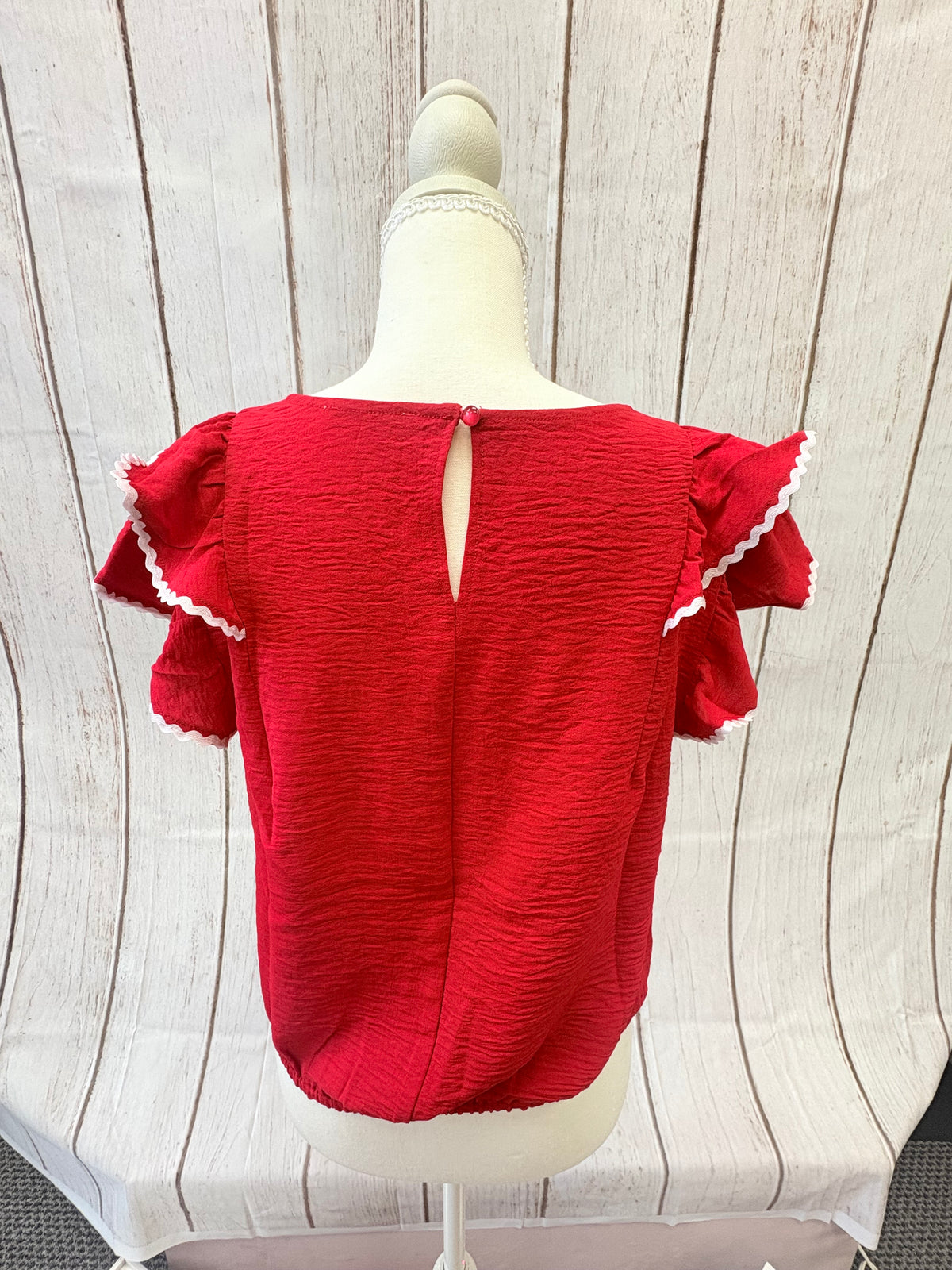 The PS Collective Flutter Airflow Top back view — back keyhole closure detail on breezy ruffle sleeve blouse
