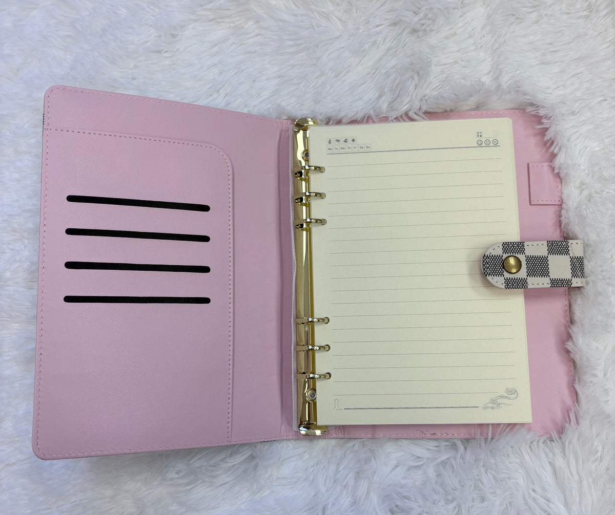 Planner binder designed for busy women, checkered exterior with pink interior for organizing schedules and notes