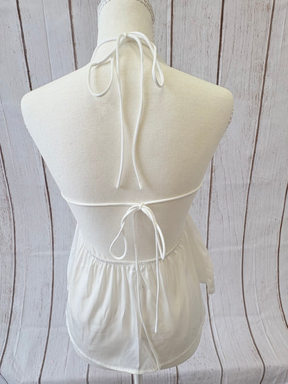 White strapless dress with a large bow on a wooden surface